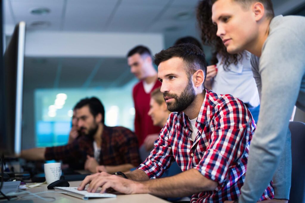 programmers-cooperating-at-information-technology-QMXP7TQ.jpg